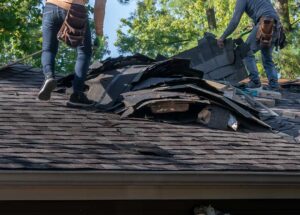 Homeowner reviewing a roofing proposal with a contractor beside a residential roof and organized material samples.